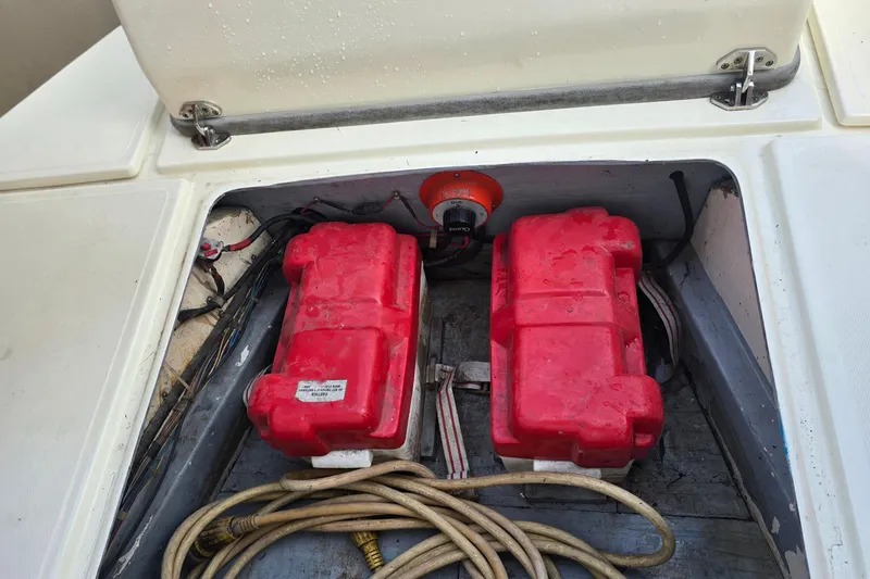 Slide: The Image of 1989 Hinterhoeller Limestone boat battery compartment with red battery boxes and cables. - 26