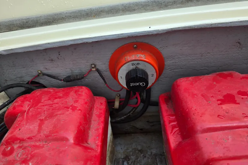 Slide: The Image of 1989 Hinterhoeller Limestone boat battery switch with red covers and wiring. - 27