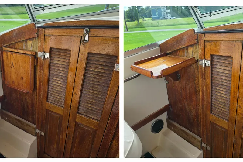 Slide: The Image of 1989 Hinterhoeller Limestone boat interior with wooden cabinets and fold-out table. - 28