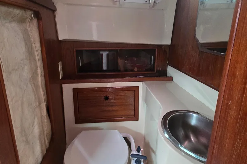 Slide: The Image of 1989 Hinterhoeller Limestone boat interior with wooden cabinetry and compact sink. - 33