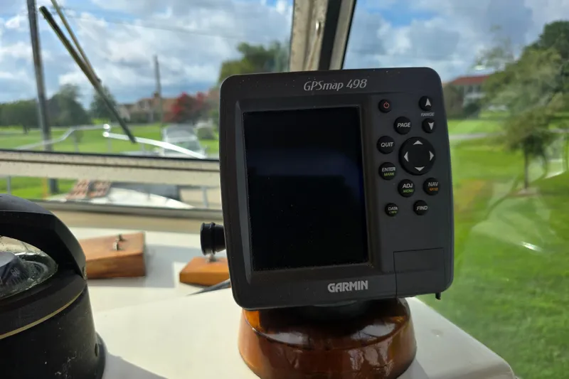 Slide: The Image of Garmin GPSmap 498 on 1989 Hinterhoeller Limestone boat dashboard, with scenic outdoor view. - 37
