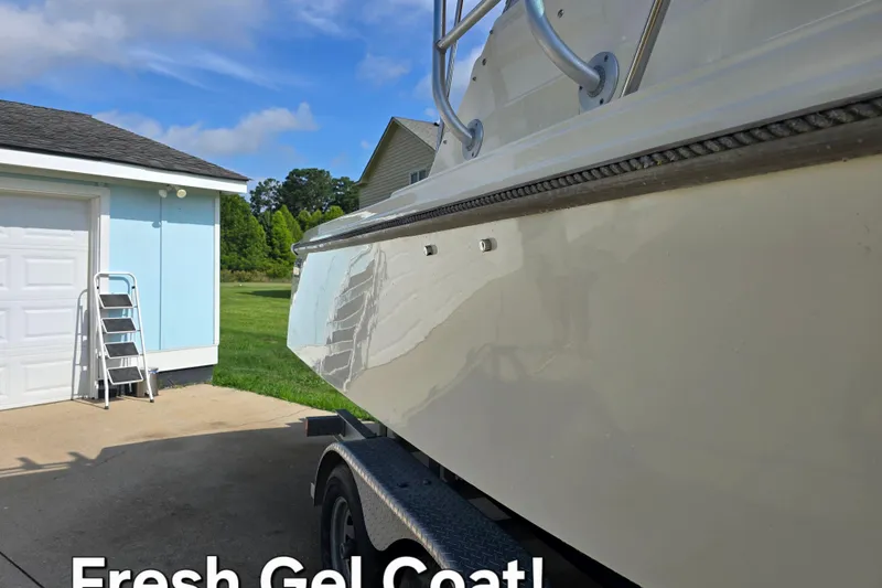 Slide: The Image of 1989 Hinterhoeller Limestone boat with fresh gel coat, parked near a garage. - 6