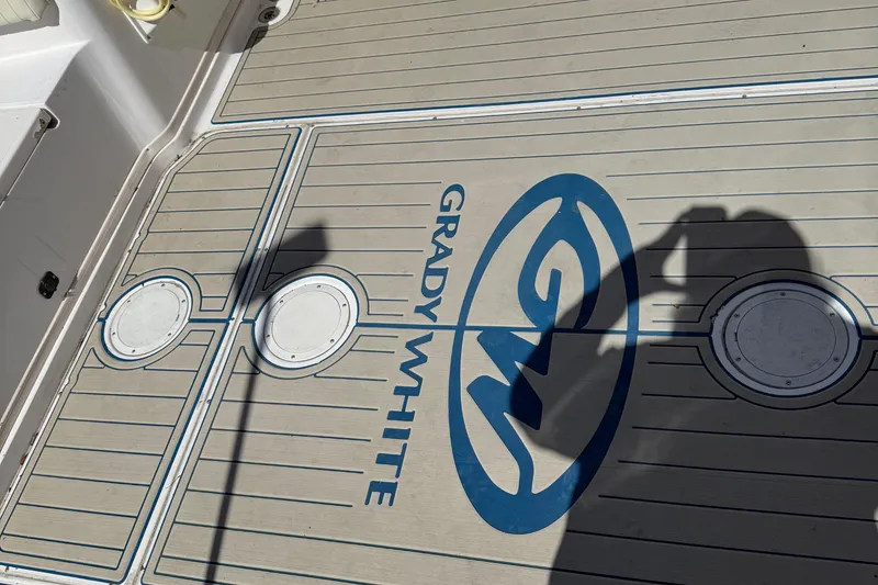 Slide: The Image of 1996 Grady-White Marlin 300 boat deck with logo and shadow. - 10