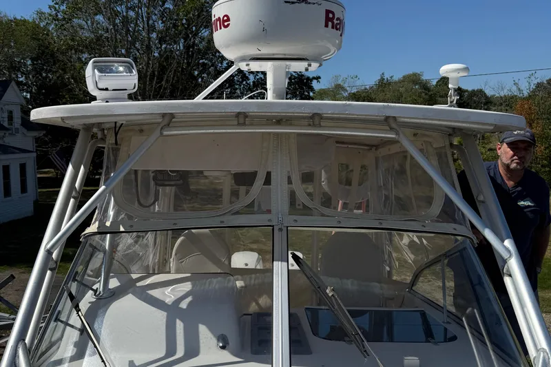 Slide: The Image of 1996 Grady-White Marlin 300 boat with radar equipment and a person standing nearby. - 11