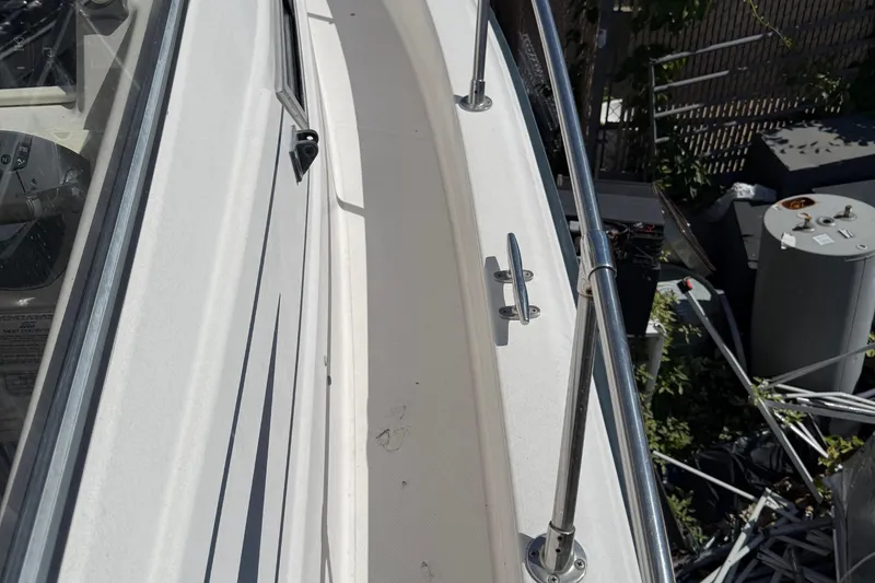 Slide: The Image of 1996 Grady-White Marlin 300 boat deck with railing and cleat. - 13