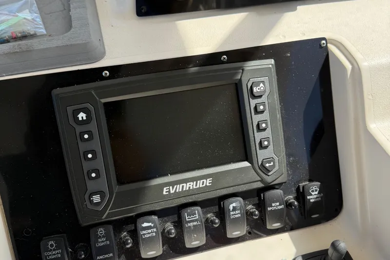 Slide: The Image of Evinrude control panel on 1996 Grady-White Marlin 300 boat dashboard. - 15