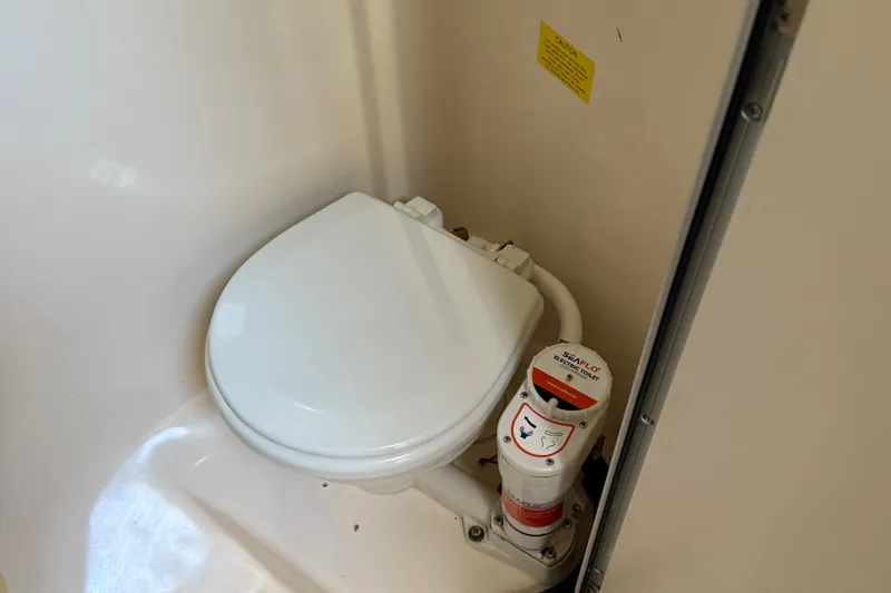 Slide: The Image of Boat toilet in 1996 Grady-White Marlin 300, featuring Seaflo electric system. - 20