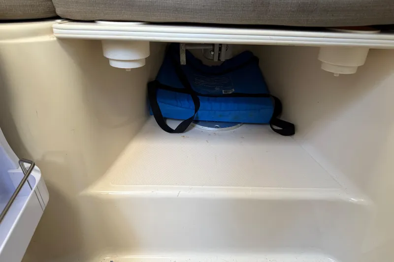 Slide: The Image of Storage compartment in a 1996 Grady-White Marlin 300 boat with a blue bag. - 22