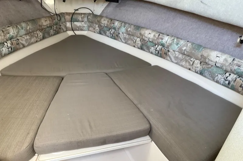 Slide: The Image of 1996 Grady-White Marlin 300 cabin interior with cushioned seating. - 23