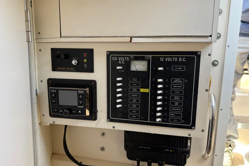 Slide: The Image of Electrical panel of 1996 Grady-White Marlin 300 boat with control switches and gauges. - 28