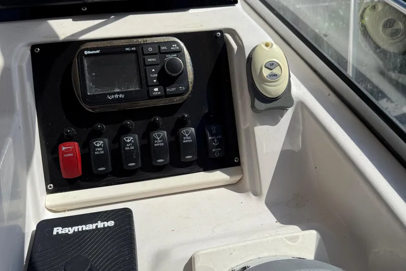 Slide: The Image of Control panel of a 1996 Grady-White Marlin 300 boat with various switches and devices. - 30
