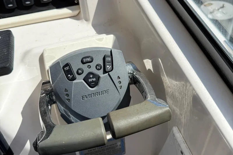 Slide: The Image of Evinrude boat throttle control on 1996 Grady-White Marlin 300, featuring various navigation buttons. - 31