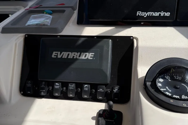 Slide: The Image of Control panel of a 1996 Grady-White Marlin 300 boat with Evinrude and Raymarine equipment. - 32