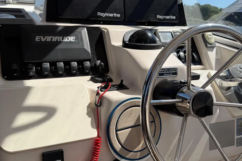 Slide: The Image of 1996 Grady-White Marlin 300 boat dashboard with steering wheel and navigation equipment. - 33