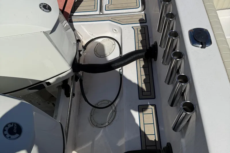 Slide: The Image of 1996 Grady-White Marlin 300 boat deck with engine and rod holders. - 35