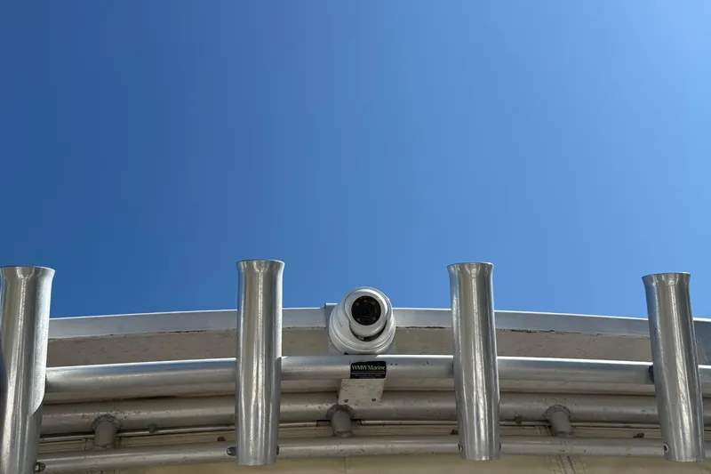 Slide: The Image of Grady-White Marlin 300 boat with rod holders and camera against clear blue sky. - 36