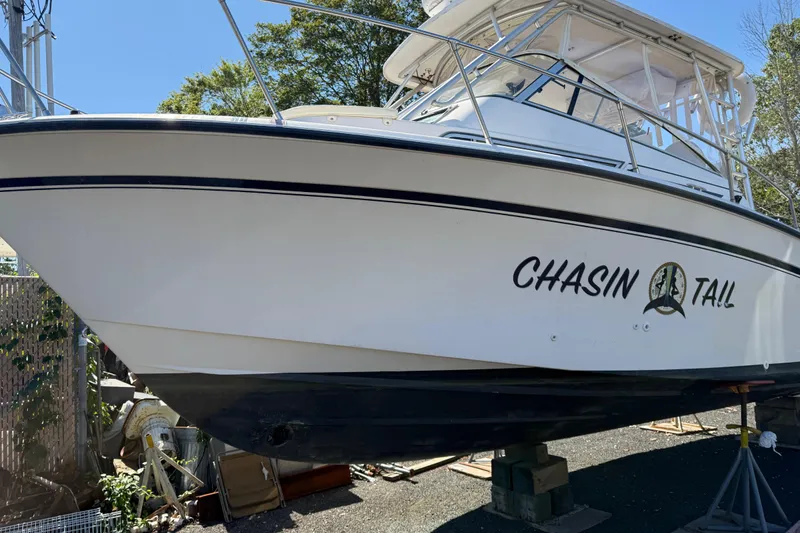 Slide: The Image of 1996 Grady-White Marlin 300 boat named "Chasin Tail" on dry dock. - 6