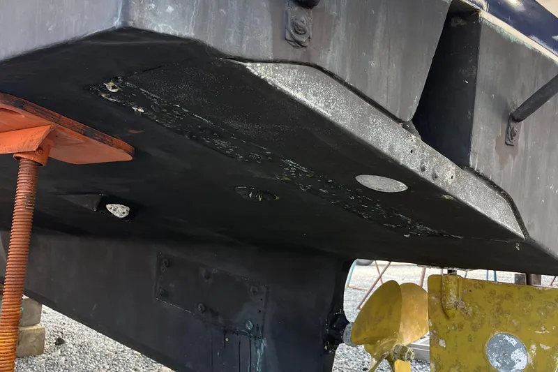 Slide: The Image of 1989 Albin 32 Sportfisher boat hull and propeller detail in dry dock. - 10