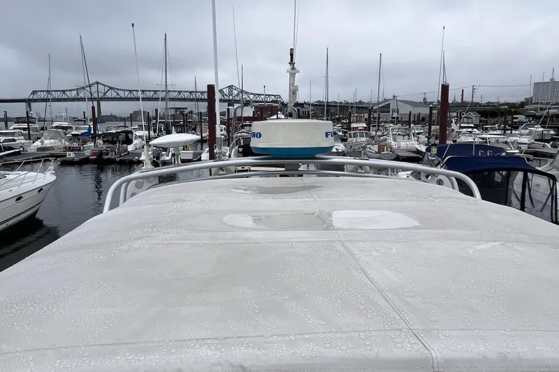 Slide: The Image of 1989 Albin 32 Sportfisher in marina, overcast sky, surrounded by boats and bridge in background. - 11