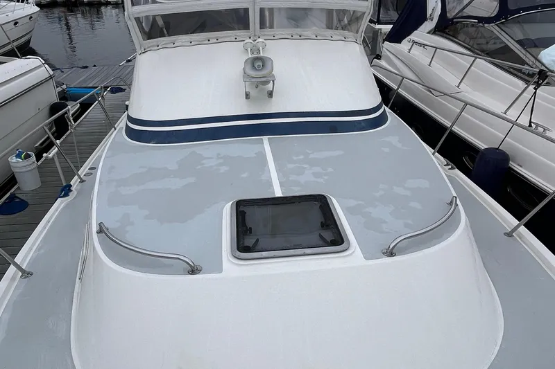 Slide: The Image of 1989 Albin 32 Sportfisher boat deck with hatch, docked alongside other vessels. - 12