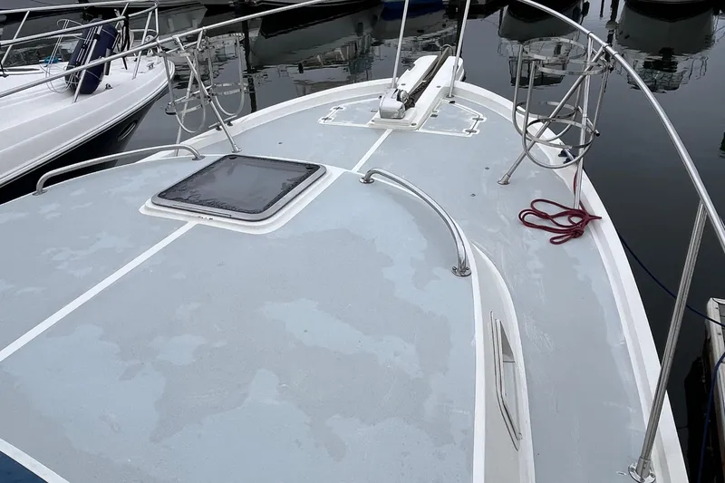Slide: The Image of 1989 Albin 32 Sportfisher boat deck with railing and hatch, docked in marina. - 13