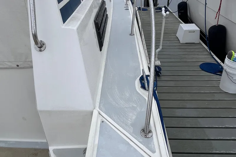 Slide: The Image of 1989 Albin 32 Sportfisher boat docked, showing deck and railing details. - 14
