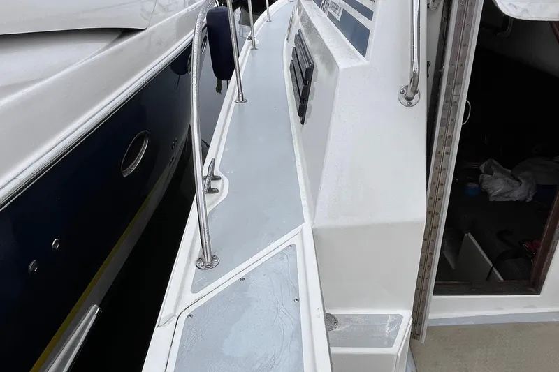 Slide: The Image of 1989 Albin 32 Sportfisher boat deck with railing and open cabin door. - 15
