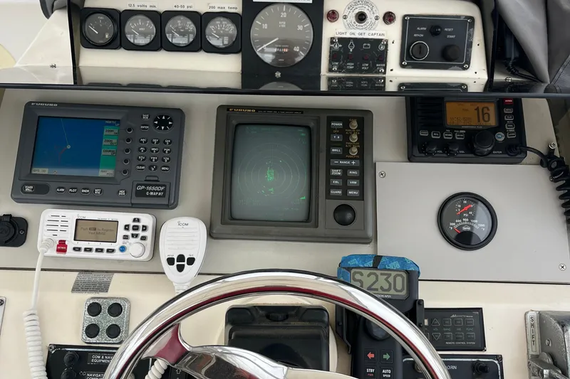 Slide: The Image of Control panel of a 1989 Albin 32 Sportfisher with navigation and communication equipment. - 16