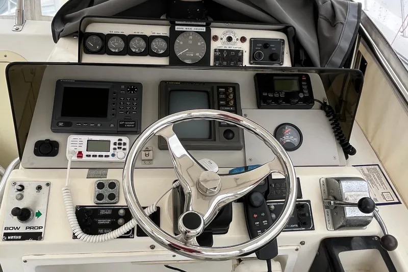 Slide: The Image of 1989 Albin 32 Sportfisher helm with navigation instruments and steering wheel. - 19