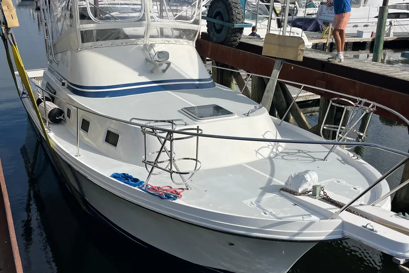 Slide: The Image of 1989 Albin 32 Sportfisher docked at marina, featuring sleek design and spacious deck. - 2