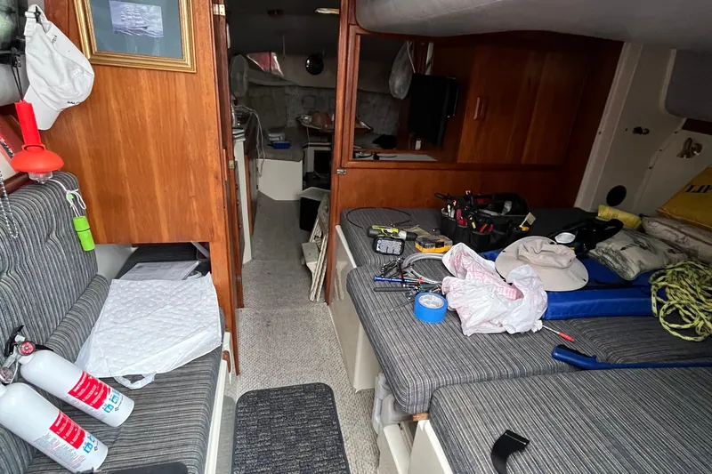Slide: The Image of Interior of 1989 Albin 32 Sportfisher with tools and equipment on striped seating. - 21