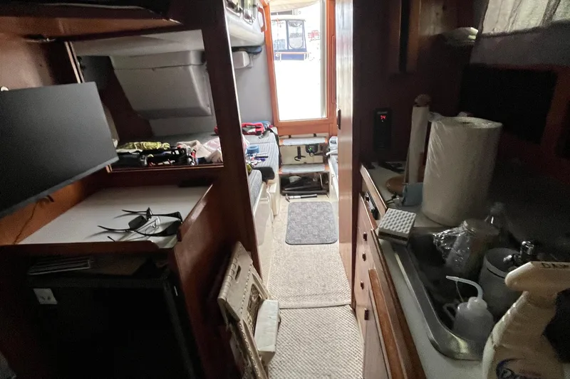 Slide: The Image of Interior of 1989 Albin 32 Sportfisher boat with kitchen and seating area. - 22