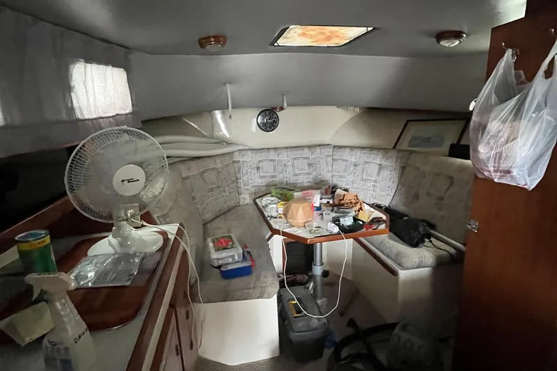 Slide: The Image of Interior of 1989 Albin 32 Sportfisher boat with seating, table, and fan. - 23