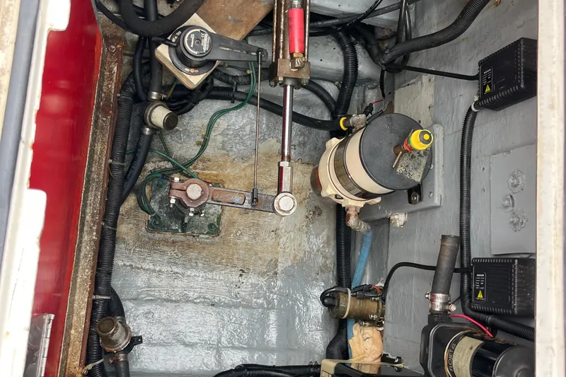 Slide: The Image of Engine compartment of a 1989 Albin 32 Sportfisher with various mechanical components and wiring. - 27