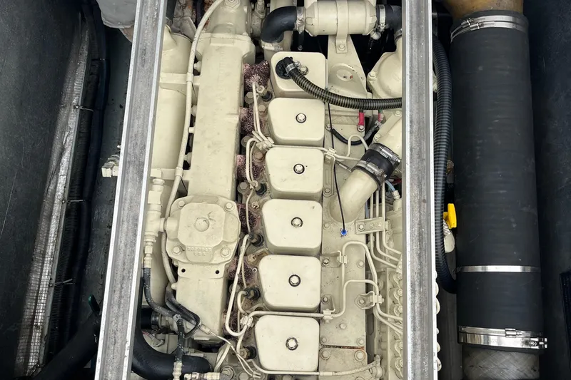 Slide: The Image of Engine compartment of a 1989 Albin 32 Sportfisher boat, showcasing detailed mechanical components. - 28