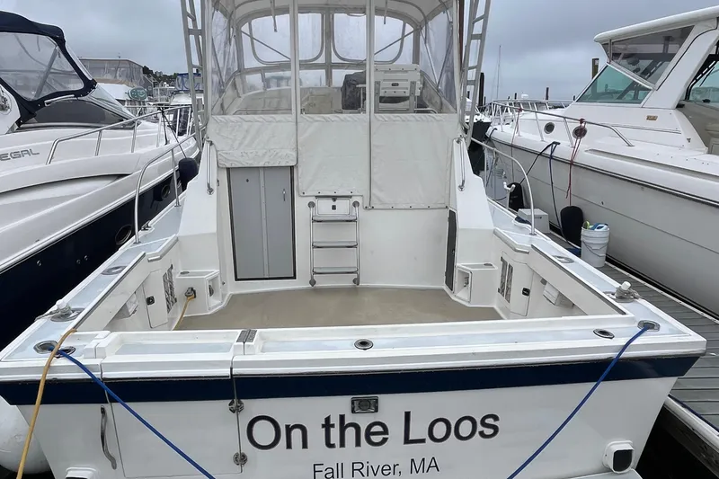 Slide: The Image of 1989 Albin 32 Sportfisher boat docked, named "On the Loos," in Fall River, MA. - 4