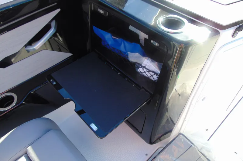 Slide: The Image of 2026 Yamaha Boats 222XD interior with storage compartment and cup holder. - 11