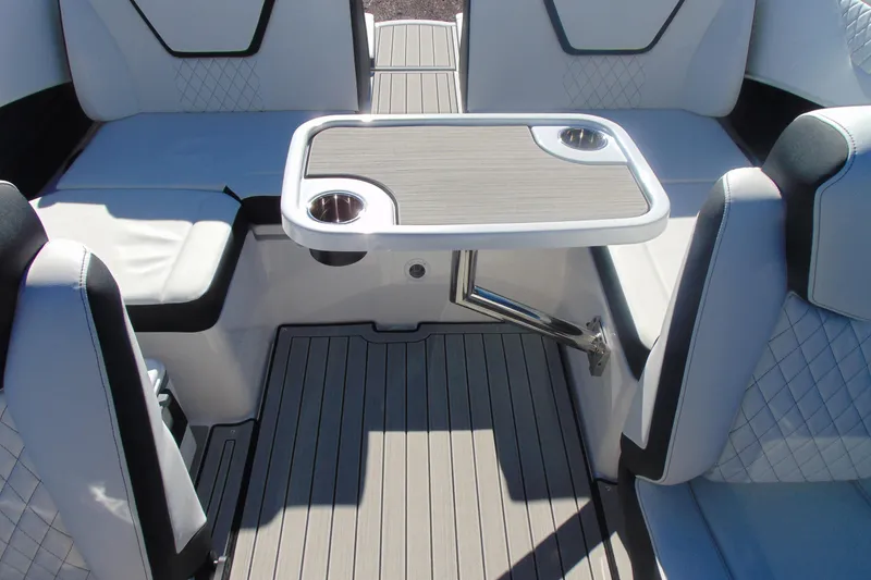 Slide: The Image of 2026 Yamaha Boats 222S interior with seating and table, featuring modern design and cup holders. - 12