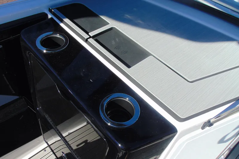Slide: The Image of 2026 Yamaha Boats 222S interior with cup holders and sleek design. - 19