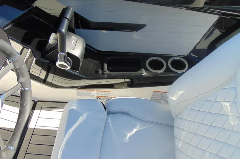 Slide: The Image of 2026 Yamaha Boats 222S interior with steering wheel, throttle, and cup holders. - 21
