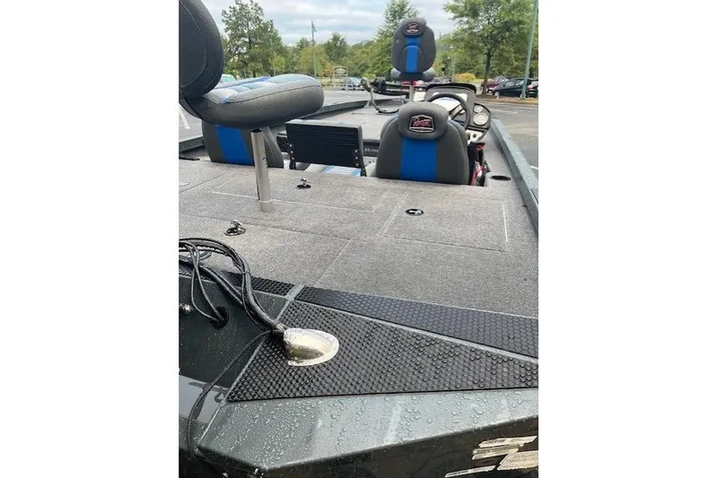 Slide: The Image of 2025 Ranger RT188P boat interior with seating and control panel, parked outdoors. - 4