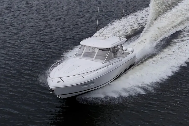Slide: The Image of 2019 Intrepid 407 Cuddy cruising on open water, creating a dynamic wake. - 22