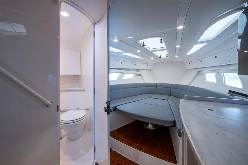 Slide: The Image of 2019 Intrepid 407 Cuddy interior with seating, skylights, and compact bathroom. - 36