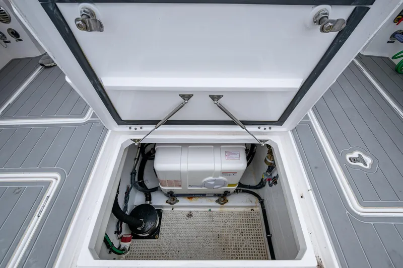 Slide: The Image of Open hatch of 2019 Intrepid 407 Cuddy boat showing internal equipment. - 46