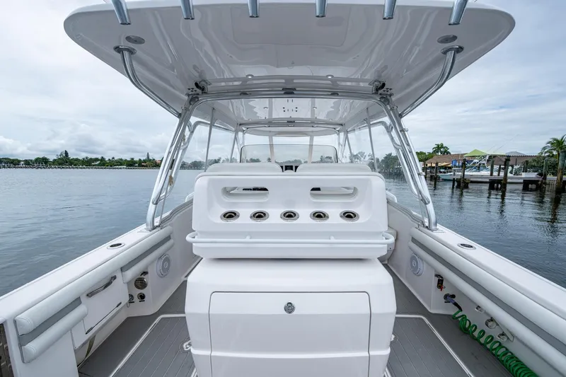 Slide: The Image of 2019 Intrepid 407 Cuddy boat interior with helm station, dockside view. - 48