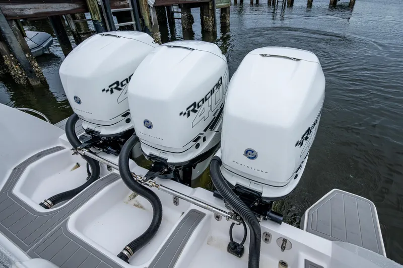 Slide: The Image of Triple outboard engines on a 2019 Intrepid 407 Cuddy boat at a dock. - 53