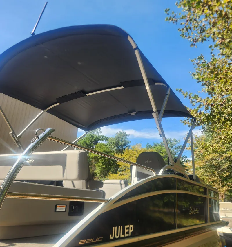 Slide: The Image of 2025 Barletta ARIA 22UC pontoon boat on trailer outside warehouse. - 3