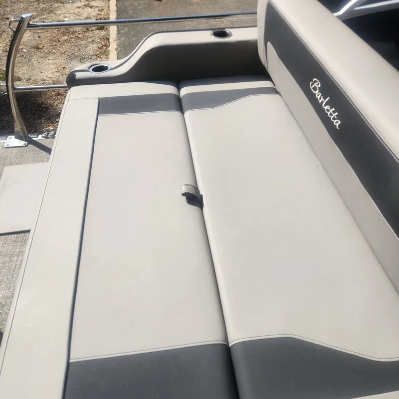 Slide: The Image of Barletta ARIA 22UC 2025 pontoon boat on trailer outside warehouse. - 7