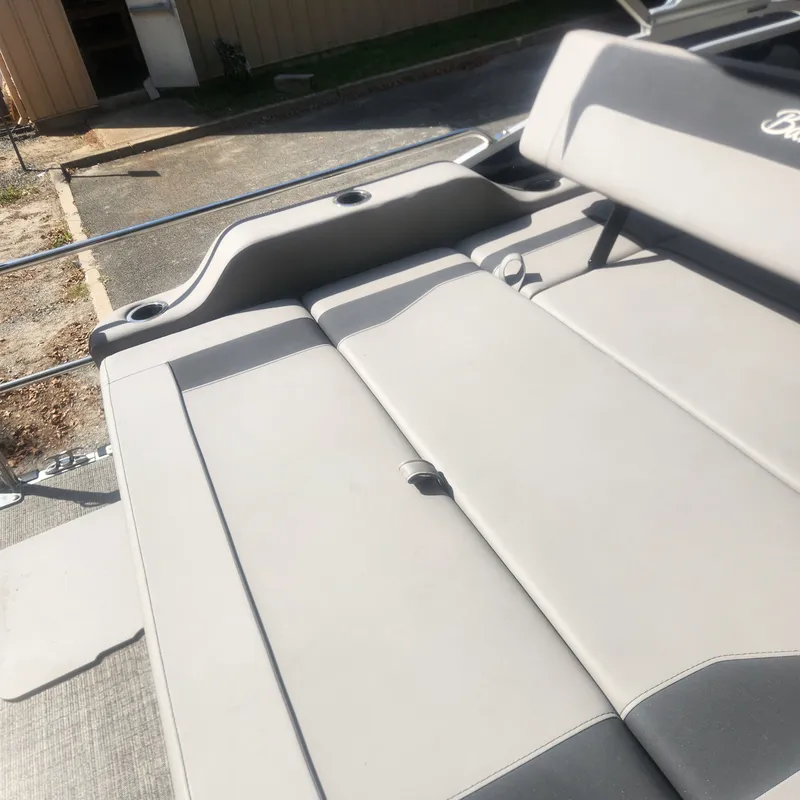 Slide: The Image of 2025 Barletta ARIA 22UC pontoon boat with canopy outside warehouse. - 8