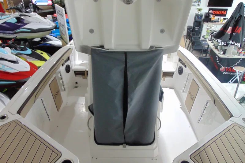 Slide: The Image of 2026 Yamaha Boats 222 FSH Sport E interior with storage and seating area. - 14